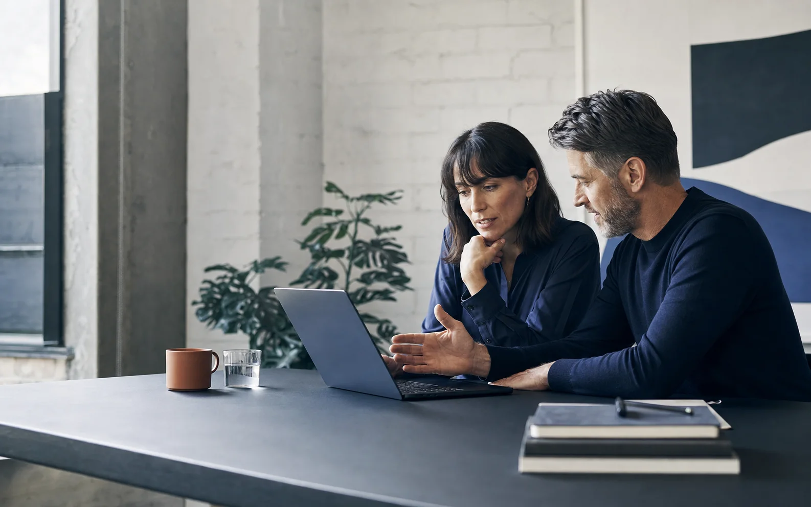 Two people working together in a focused AI consulting session